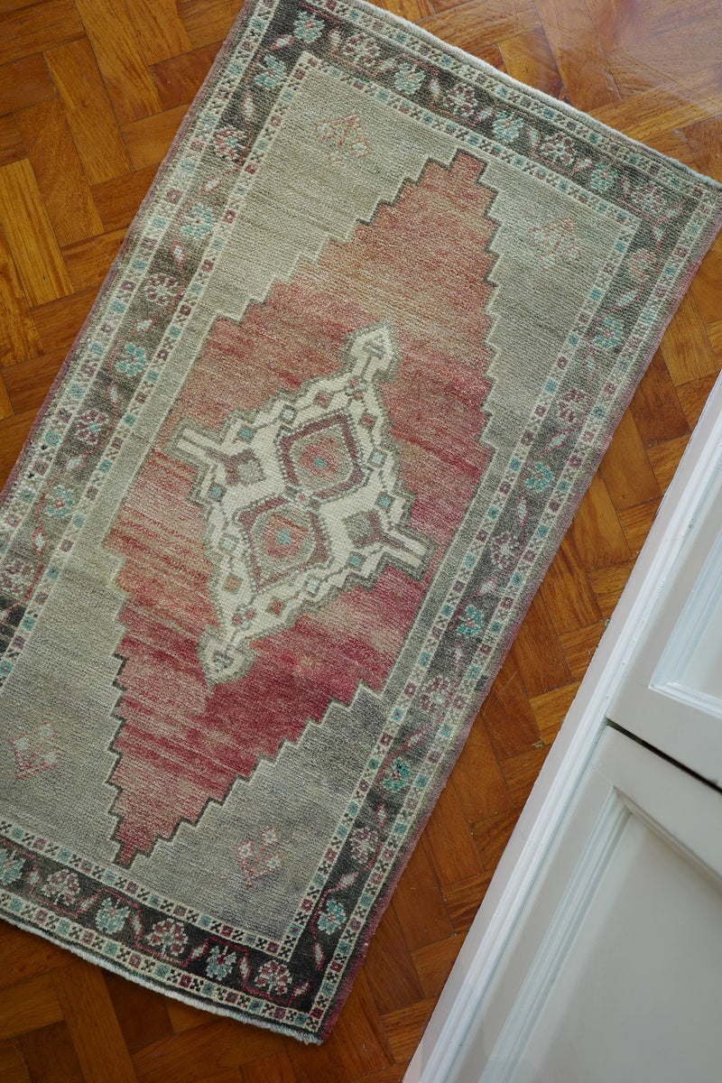 Handwoven Turkish Yastik rug with geometric patterns and rich colors