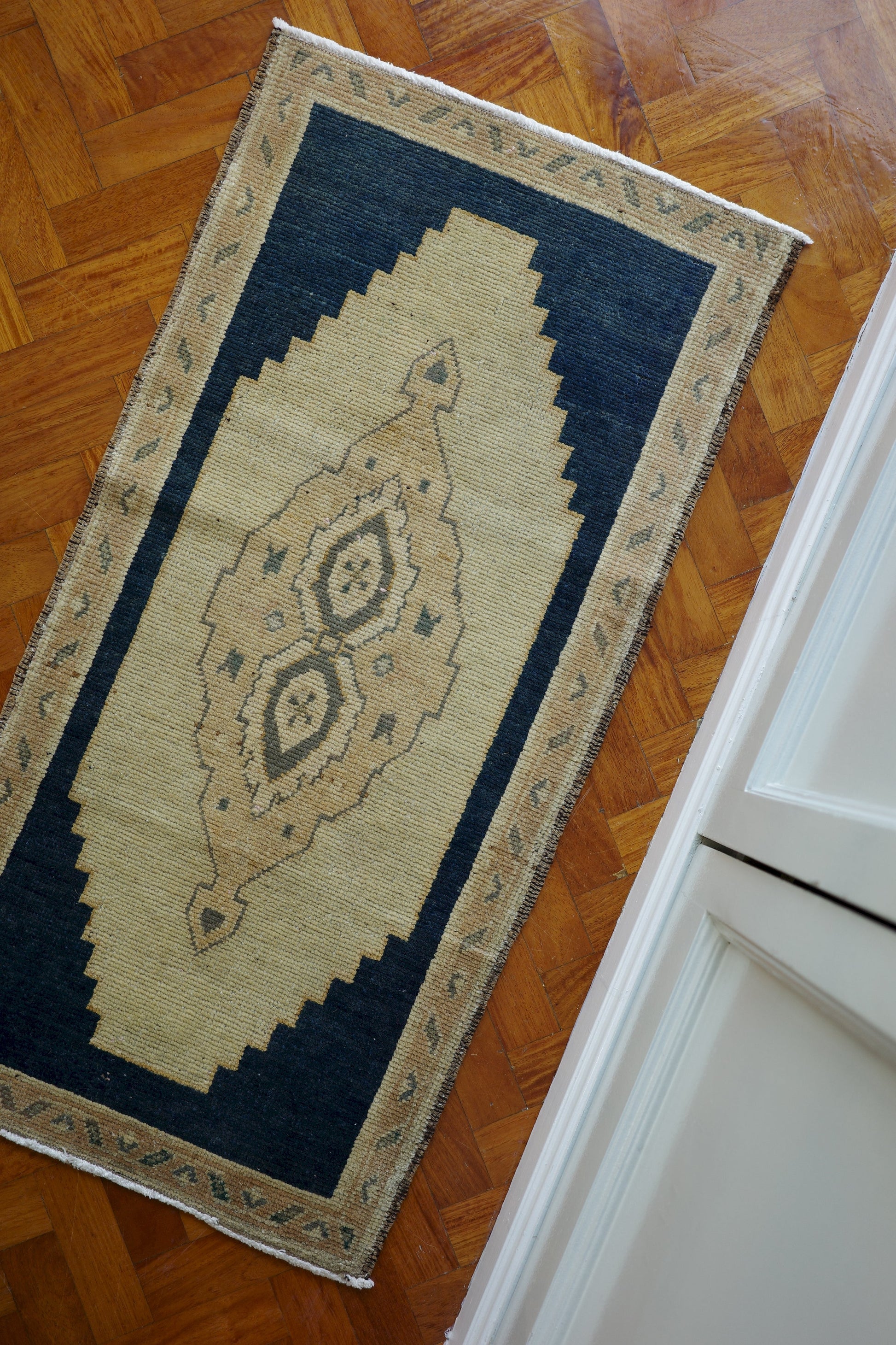 Handwoven Turkish Yastik rug with geometric patterns and rich colors