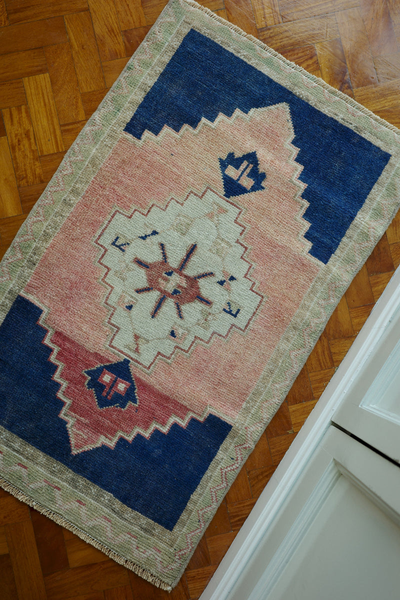 Handwoven Turkish Yastik rug with geometric patterns and rich colors