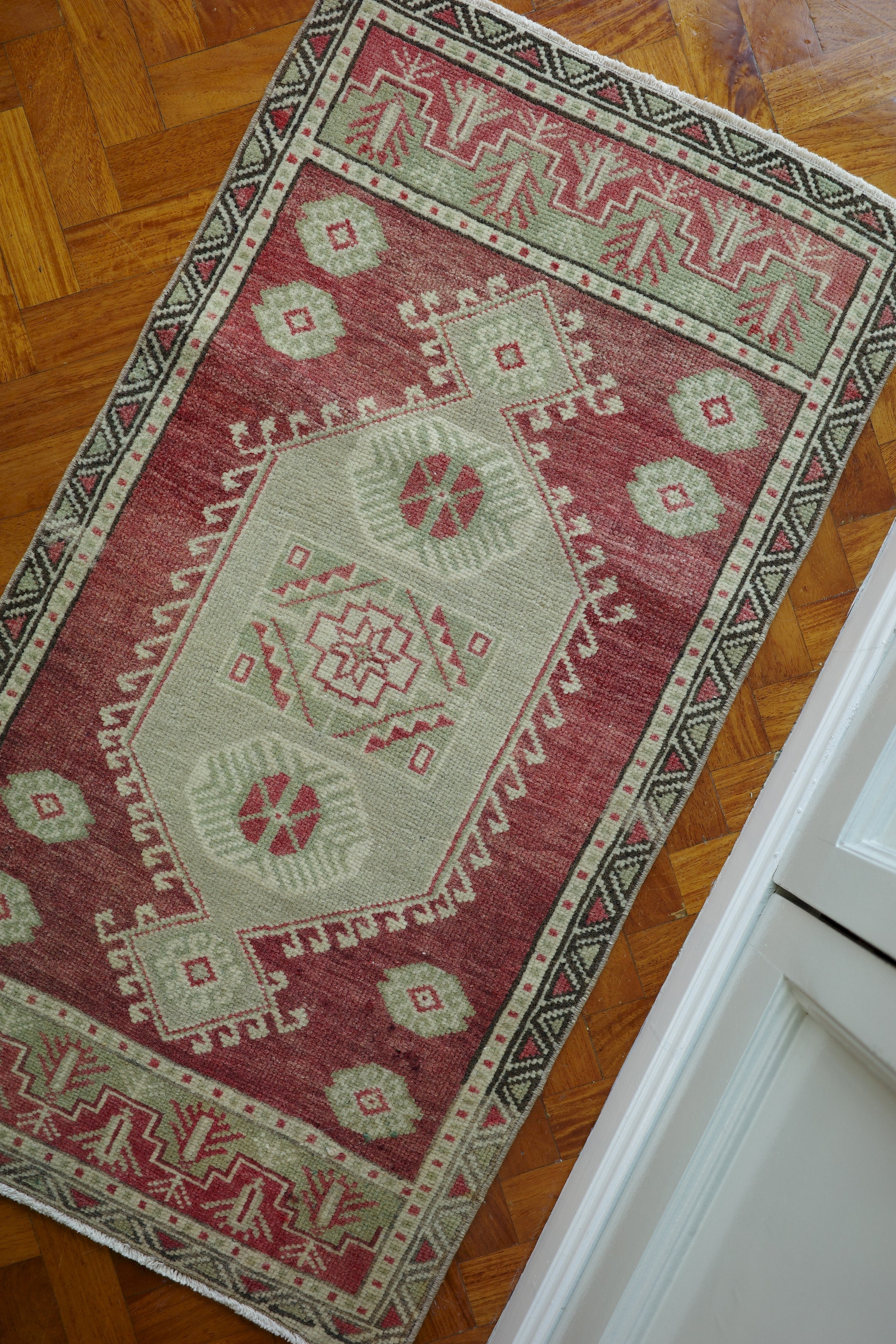 Handwoven Turkish Yastik rug with geometric patterns and rich colors
