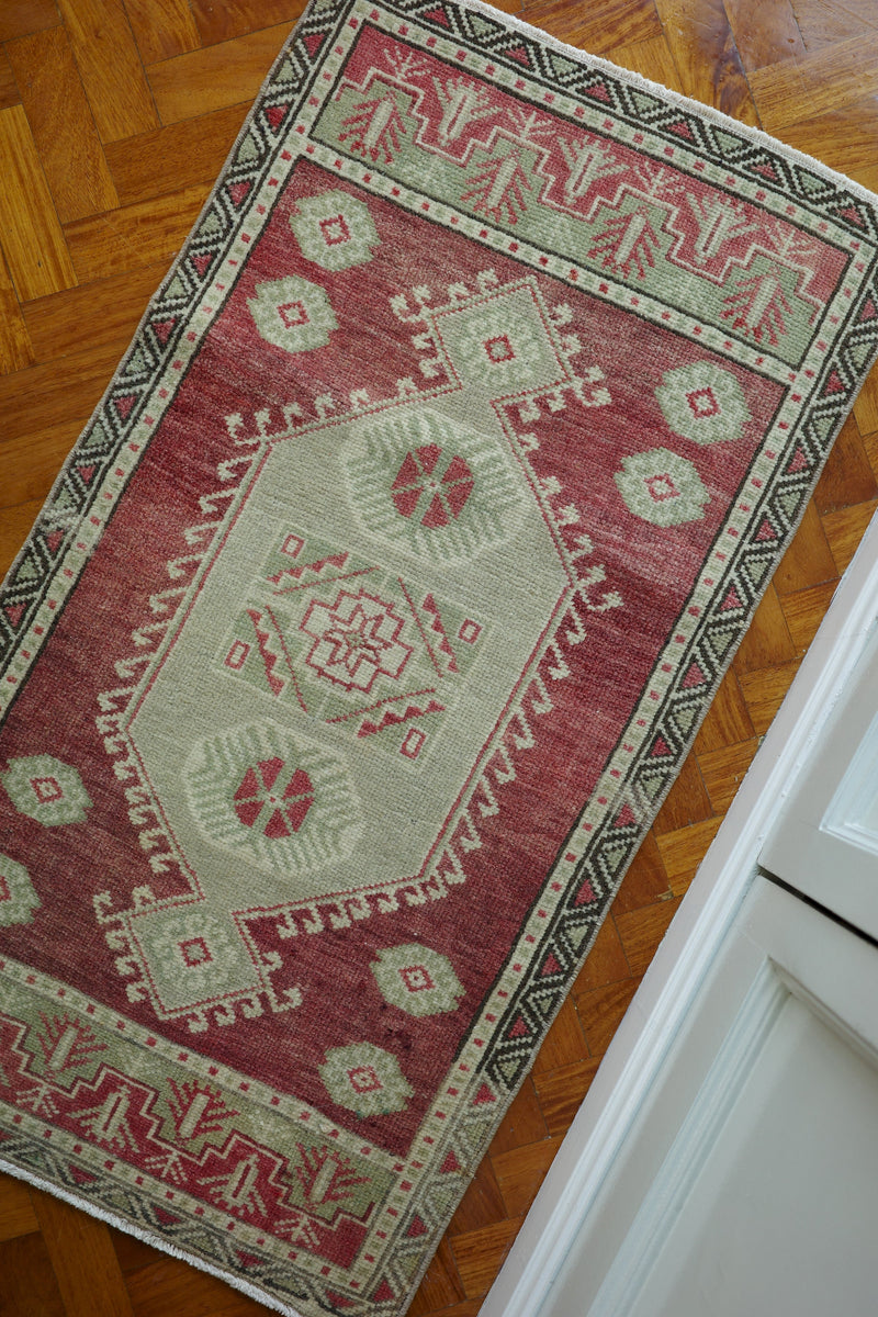 Handwoven Turkish Yastik rug with geometric patterns and rich colors