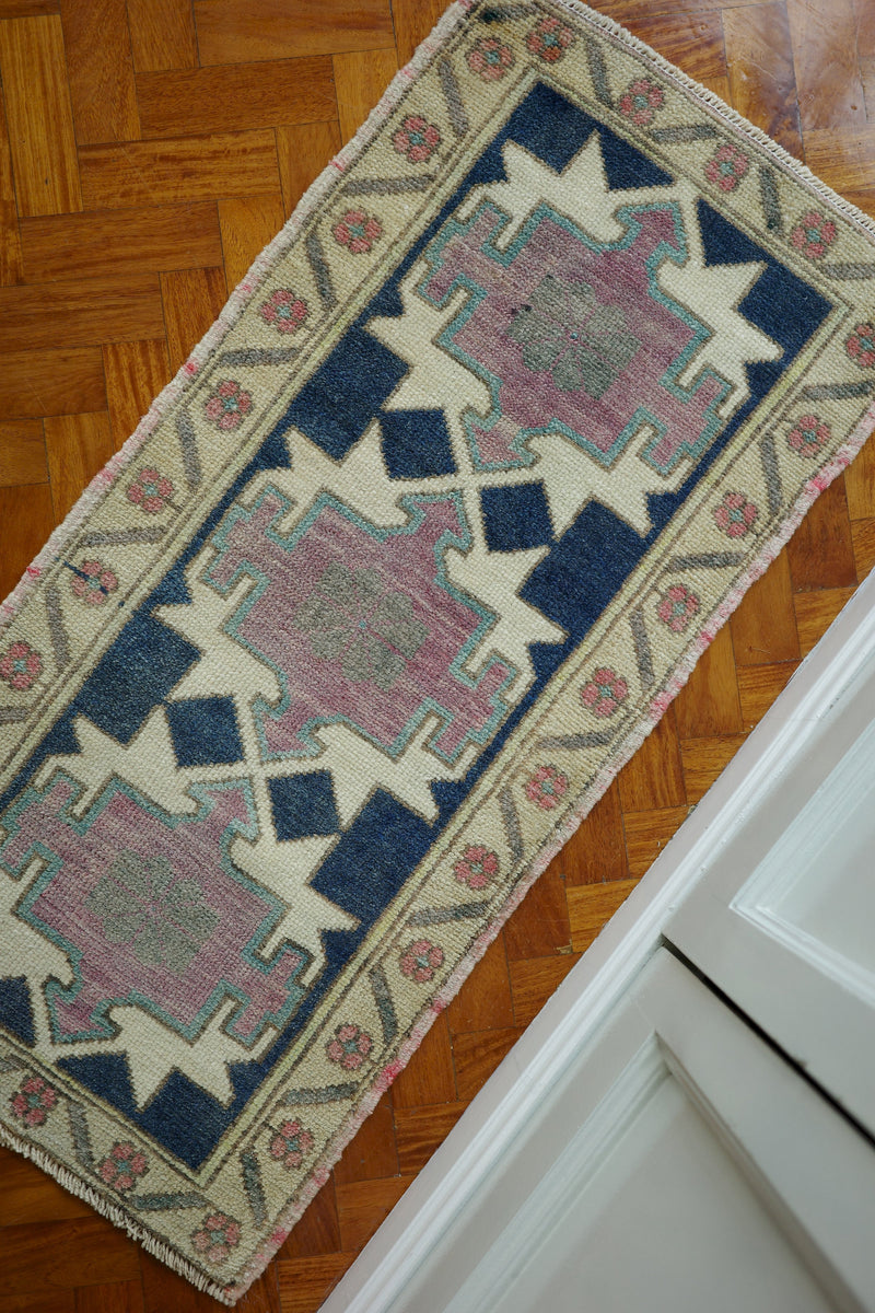 Handwoven Turkish Yastik rug with geometric patterns and rich colors
