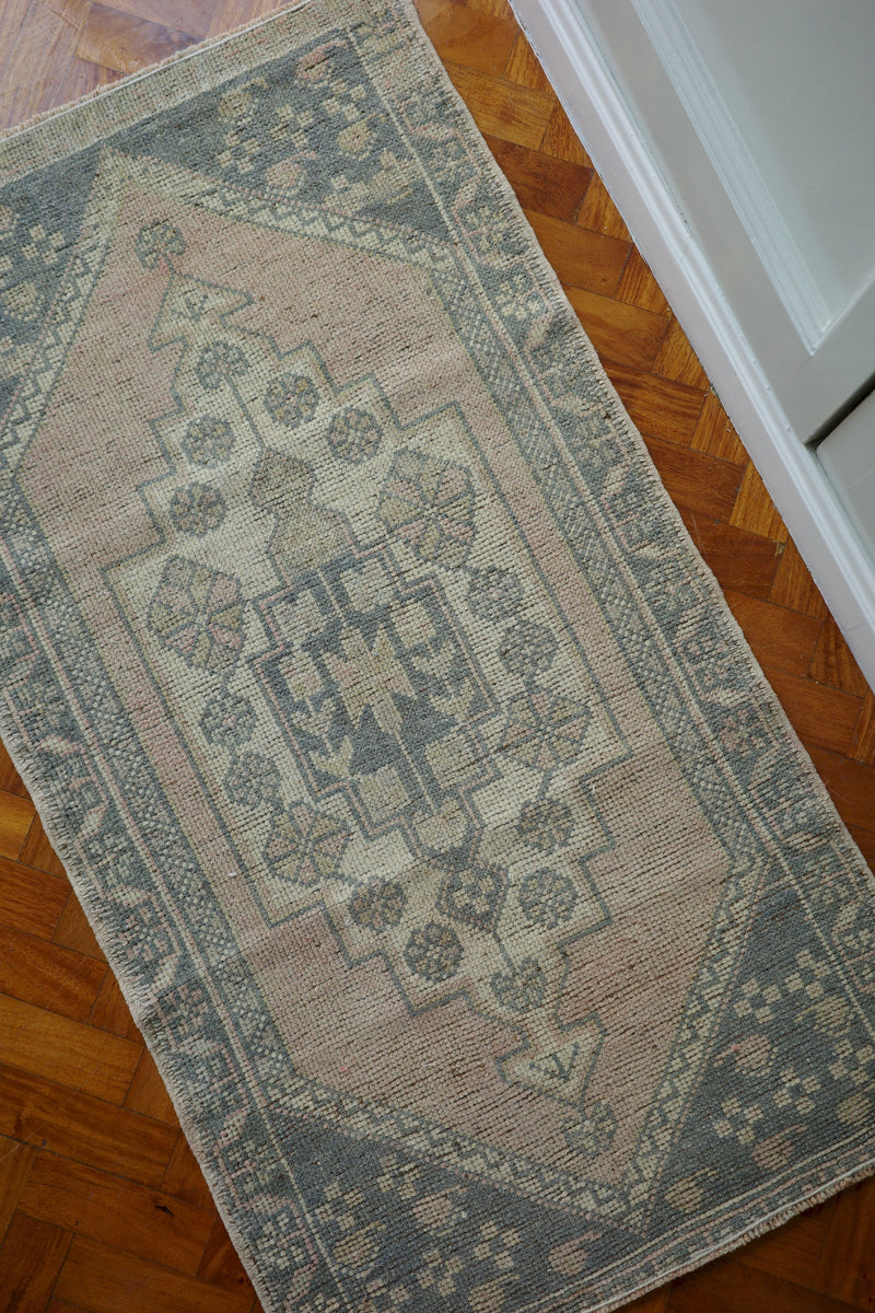 Handwoven Turkish Yastik rug with geometric patterns and rich colors