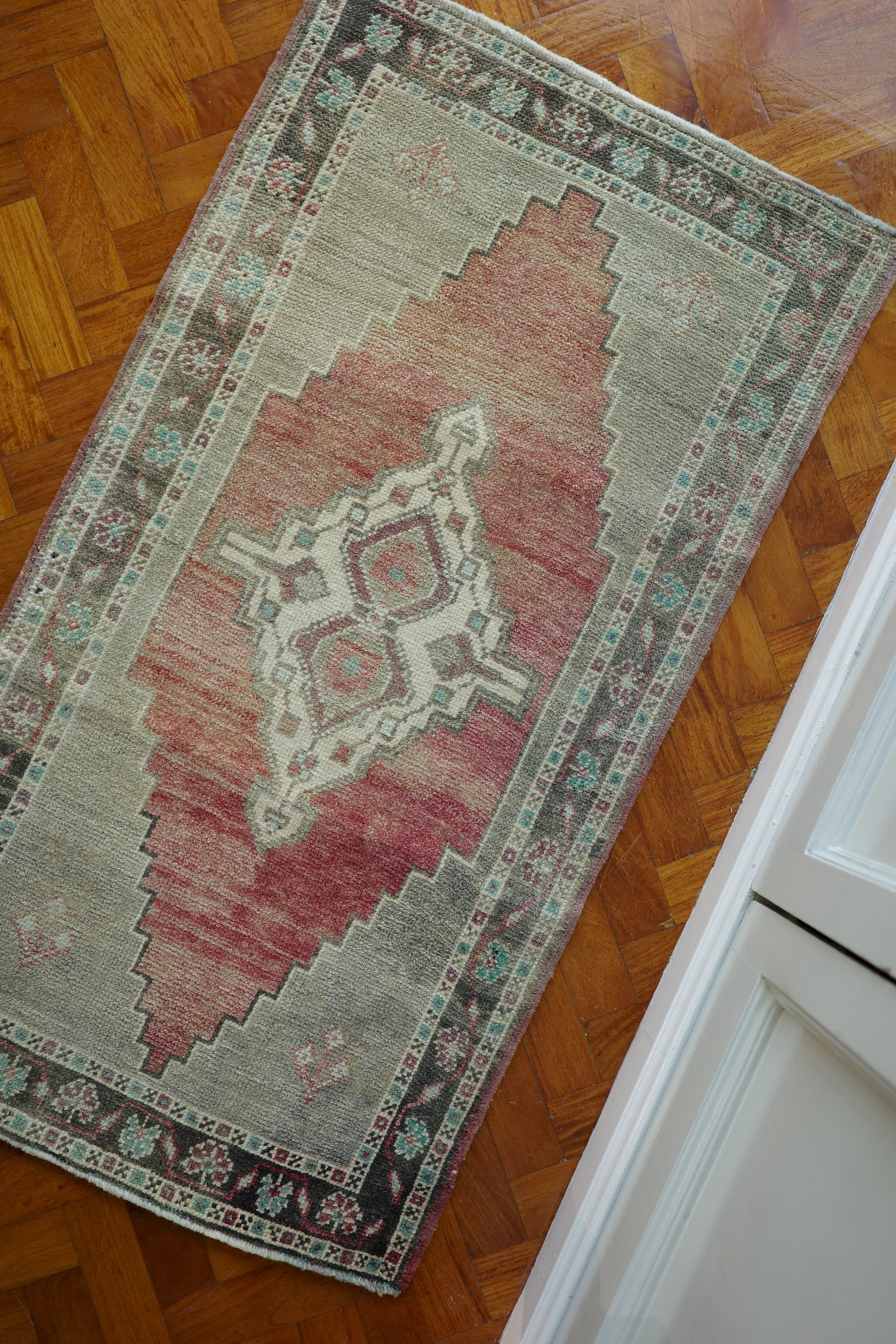 Handwoven Turkish Yastik rug with geometric patterns and rich colors