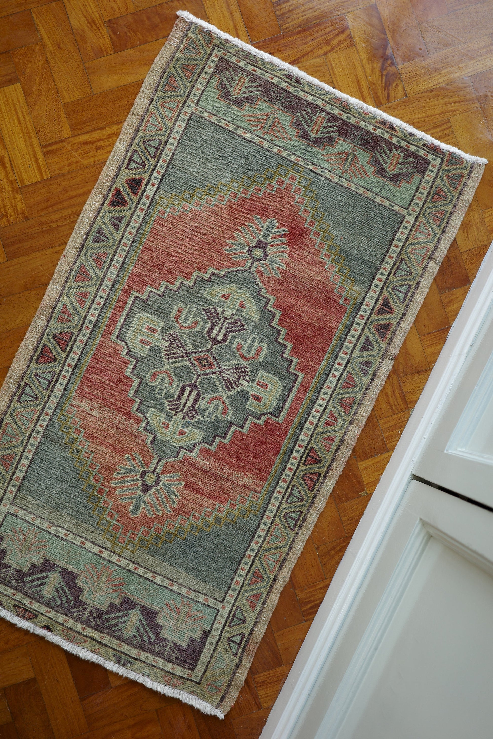 Handwoven Turkish Yastik rug with geometric patterns and rich colors