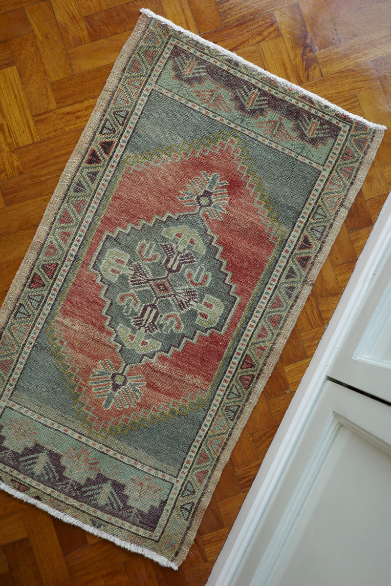 Handwoven Turkish Yastik rug with geometric patterns and rich colors