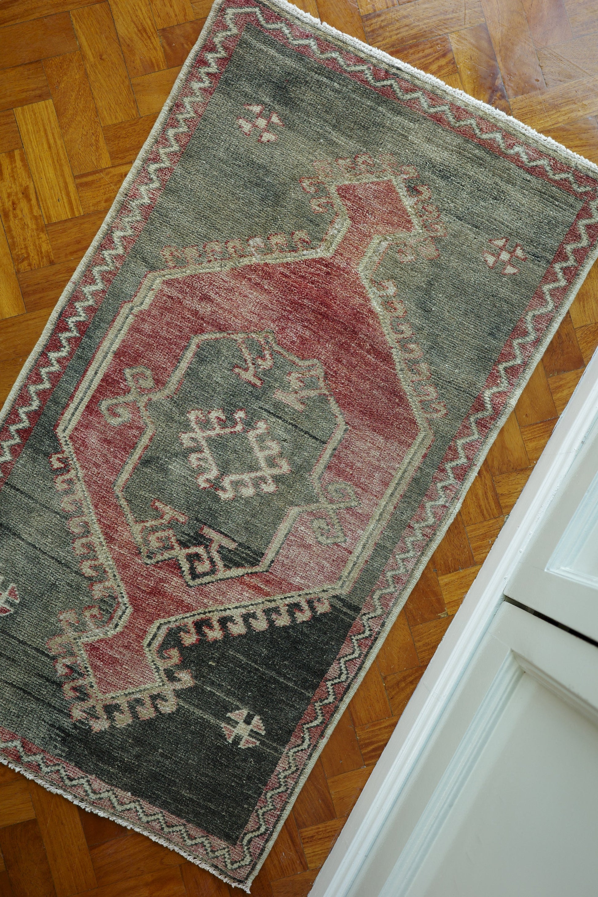 Handwoven Turkish Yastik rug with geometric patterns and rich colors