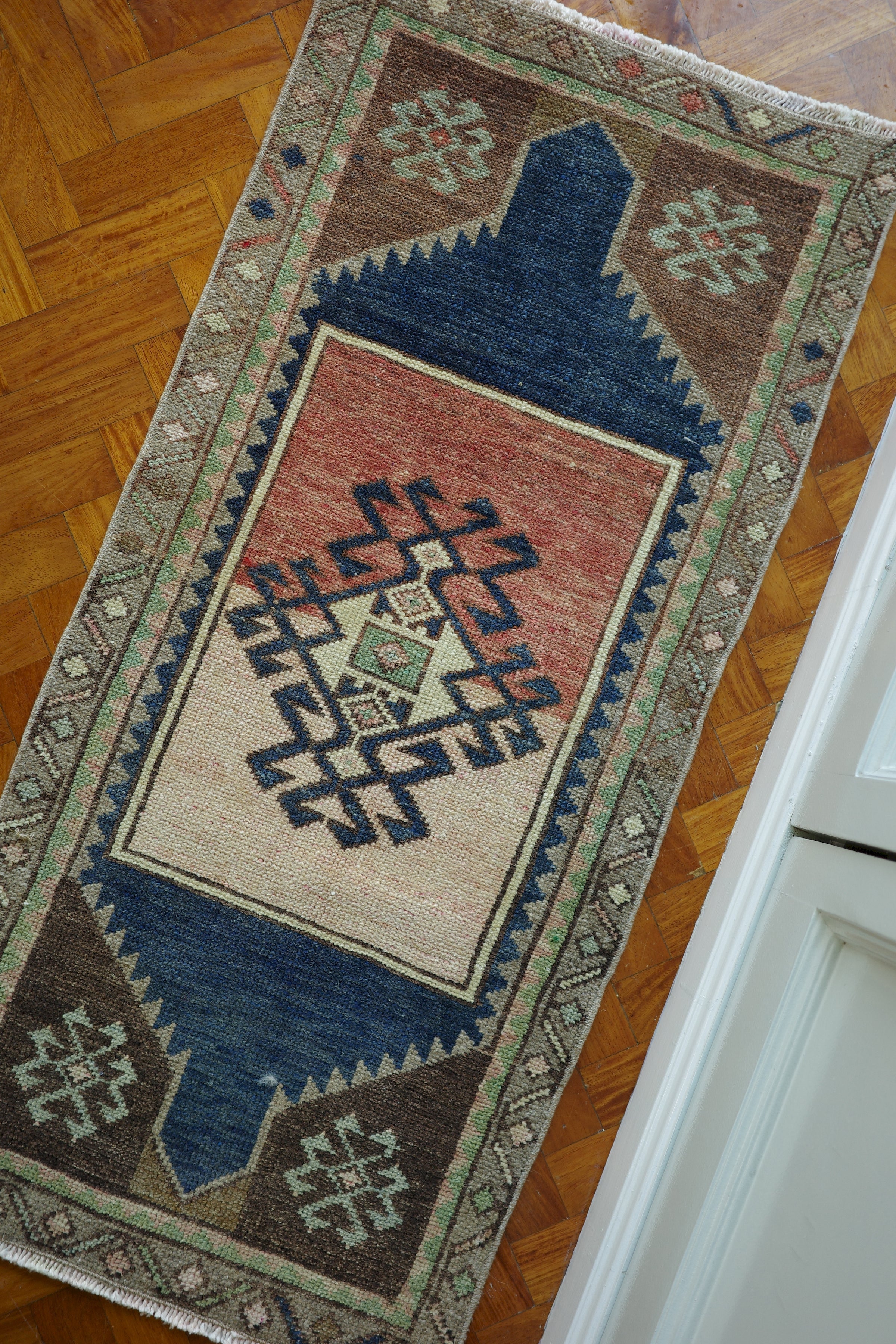 Handwoven Turkish Yastik rug with geometric patterns and rich colors