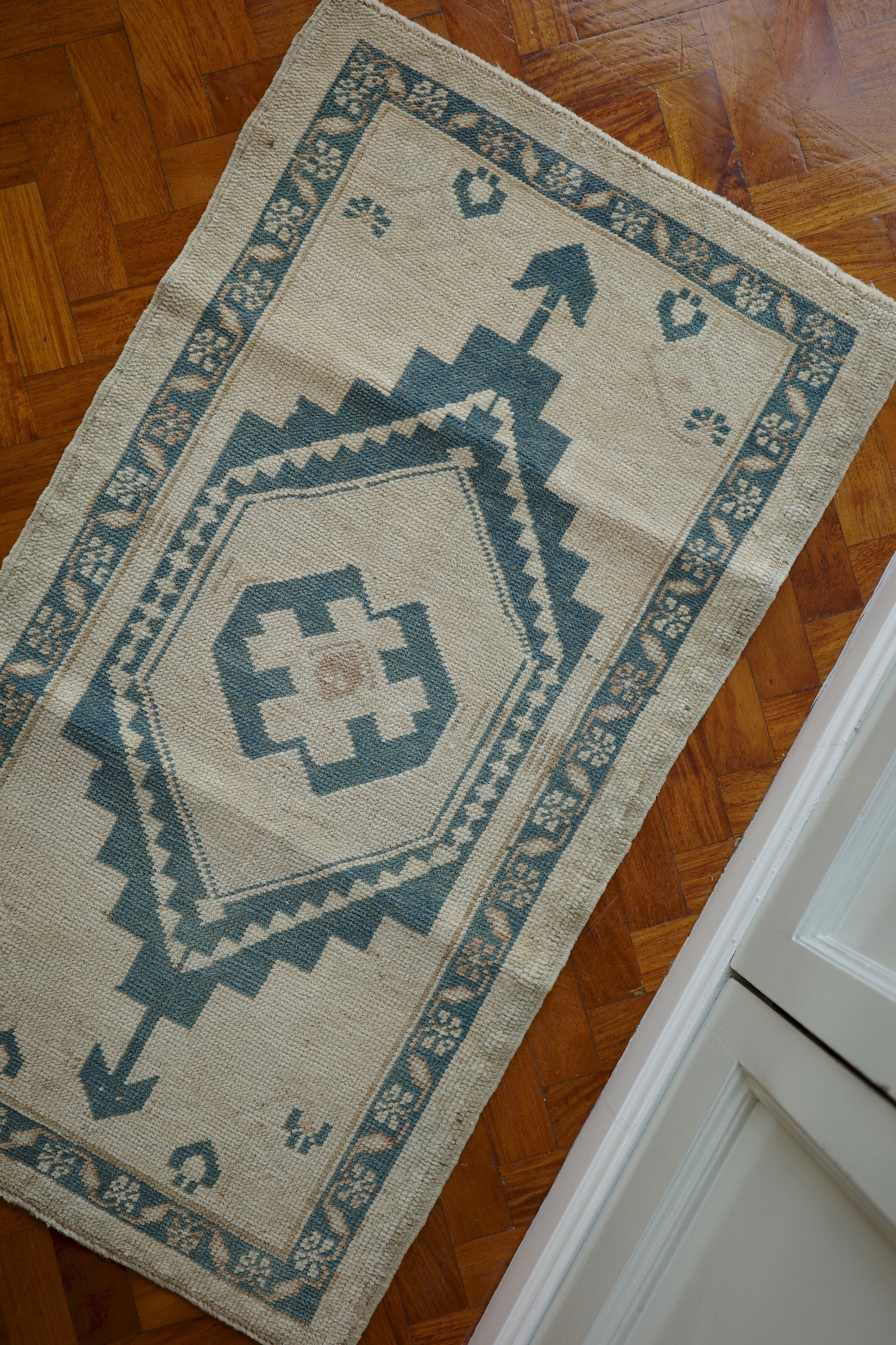 Handwoven Turkish Yastik rug with geometric patterns and rich colors