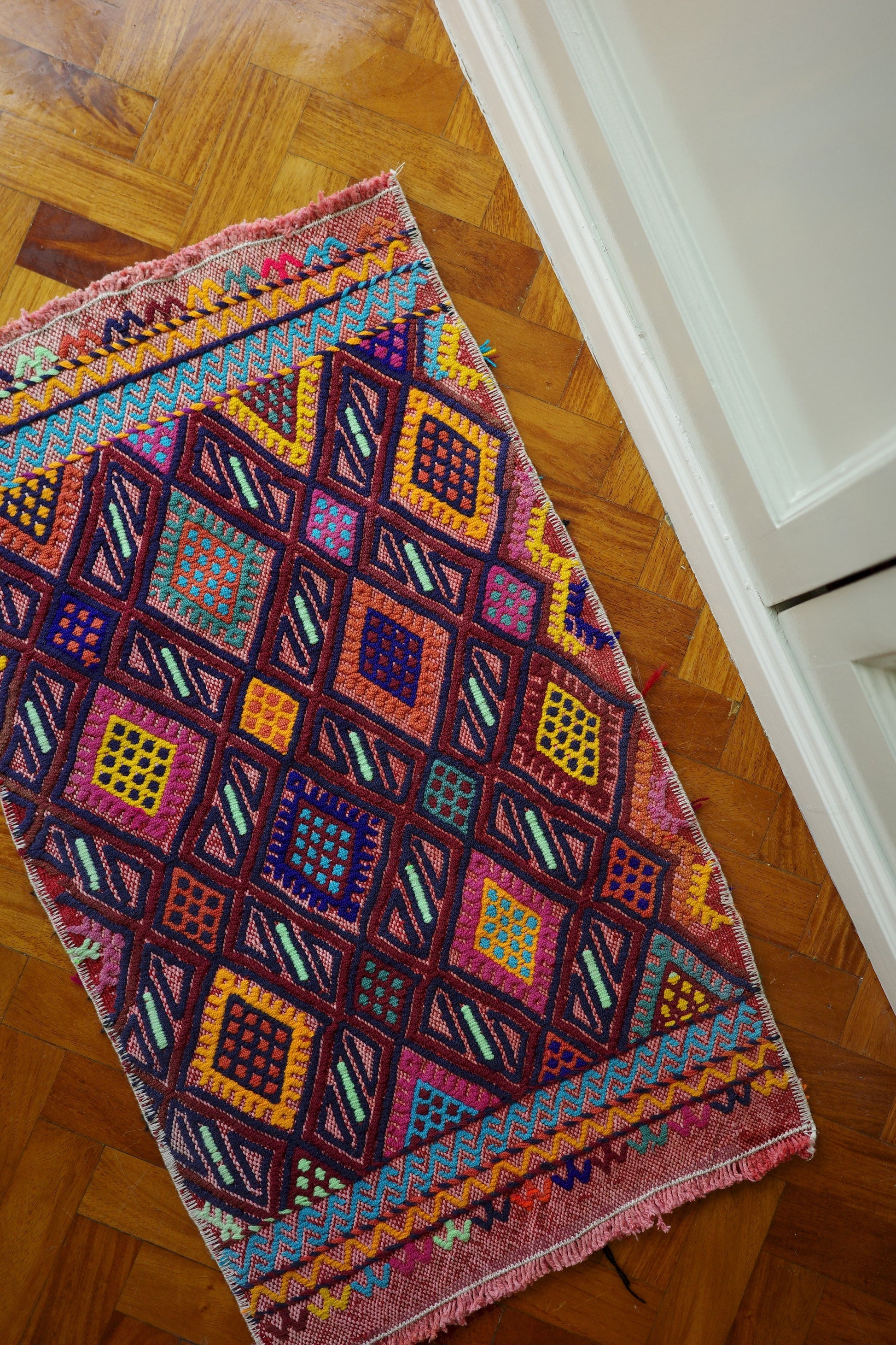 Handwoven Turkish Yastik rug with geometric patterns and rich colors