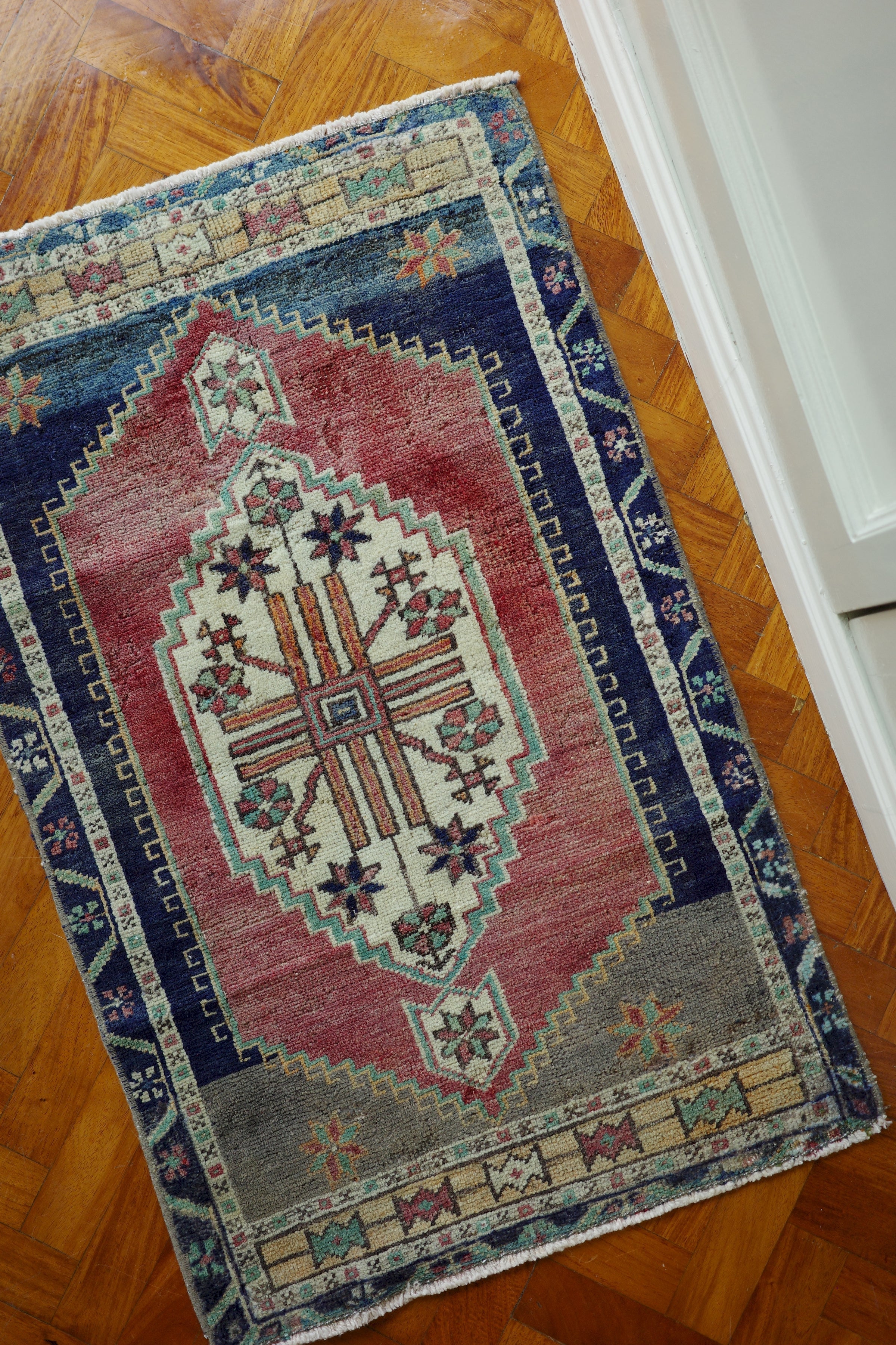 Handwoven Turkish Yastik rug with geometric patterns and rich colors