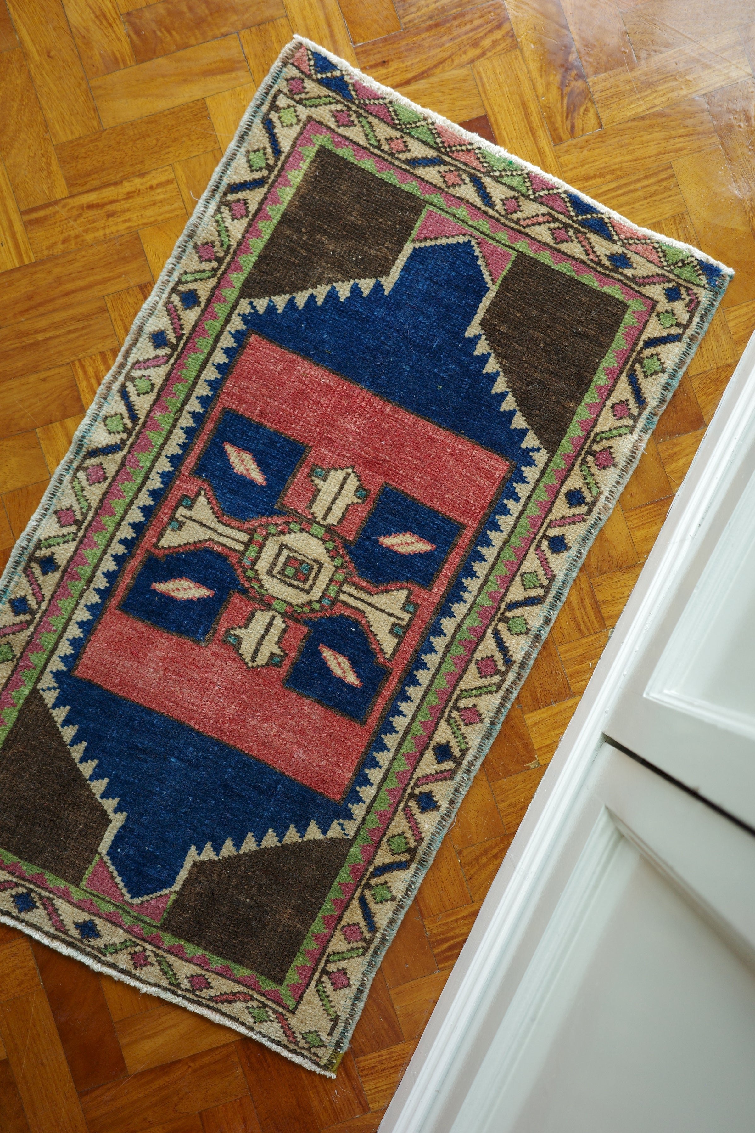 Handwoven Turkish Yastik rug with geometric patterns and rich colors