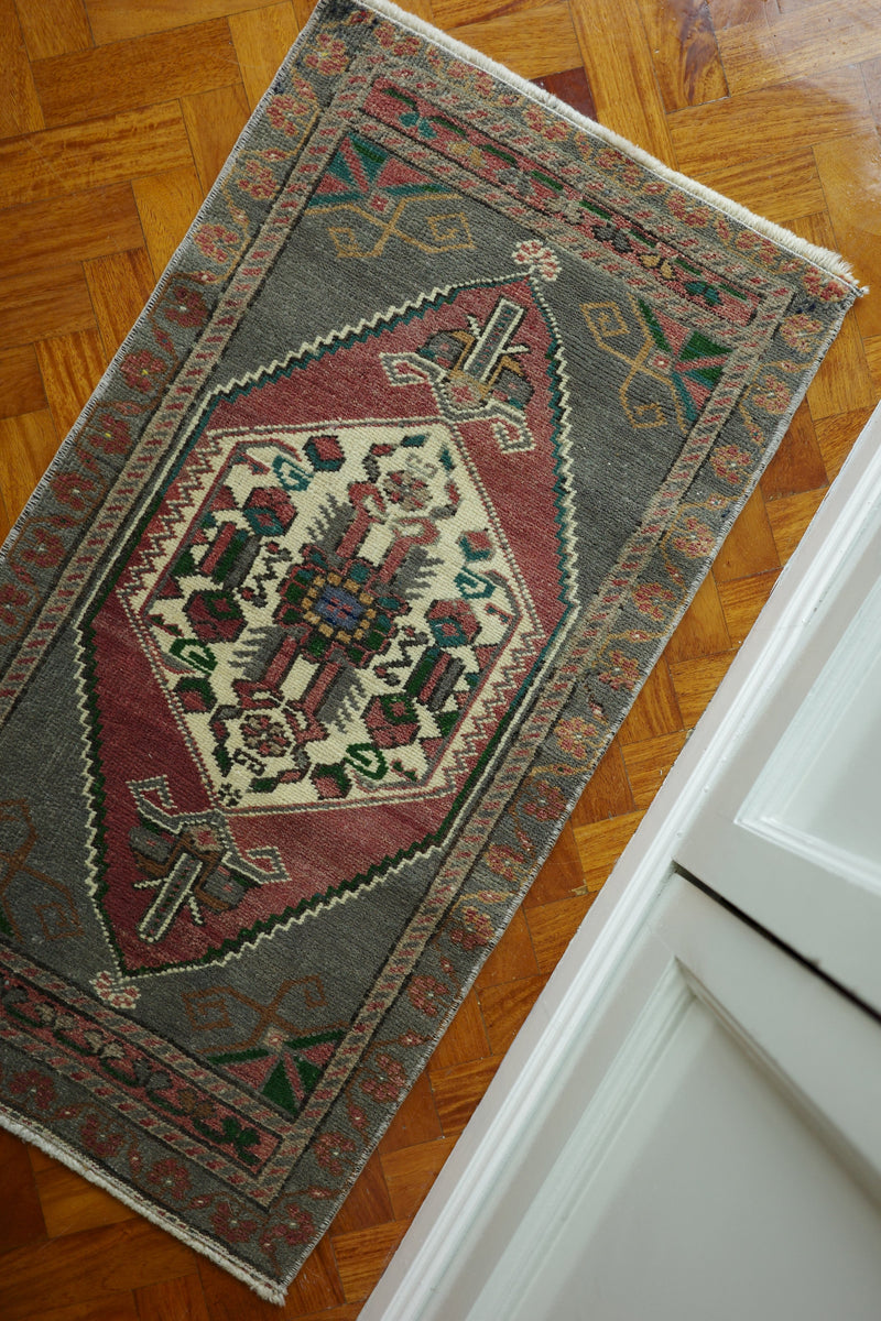 Handwoven Turkish Yastik rug with geometric patterns and rich colors