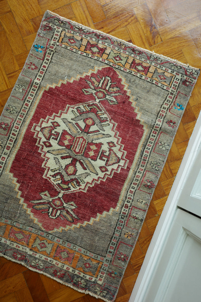 Handwoven Turkish Yastik rug with geometric patterns and rich colors