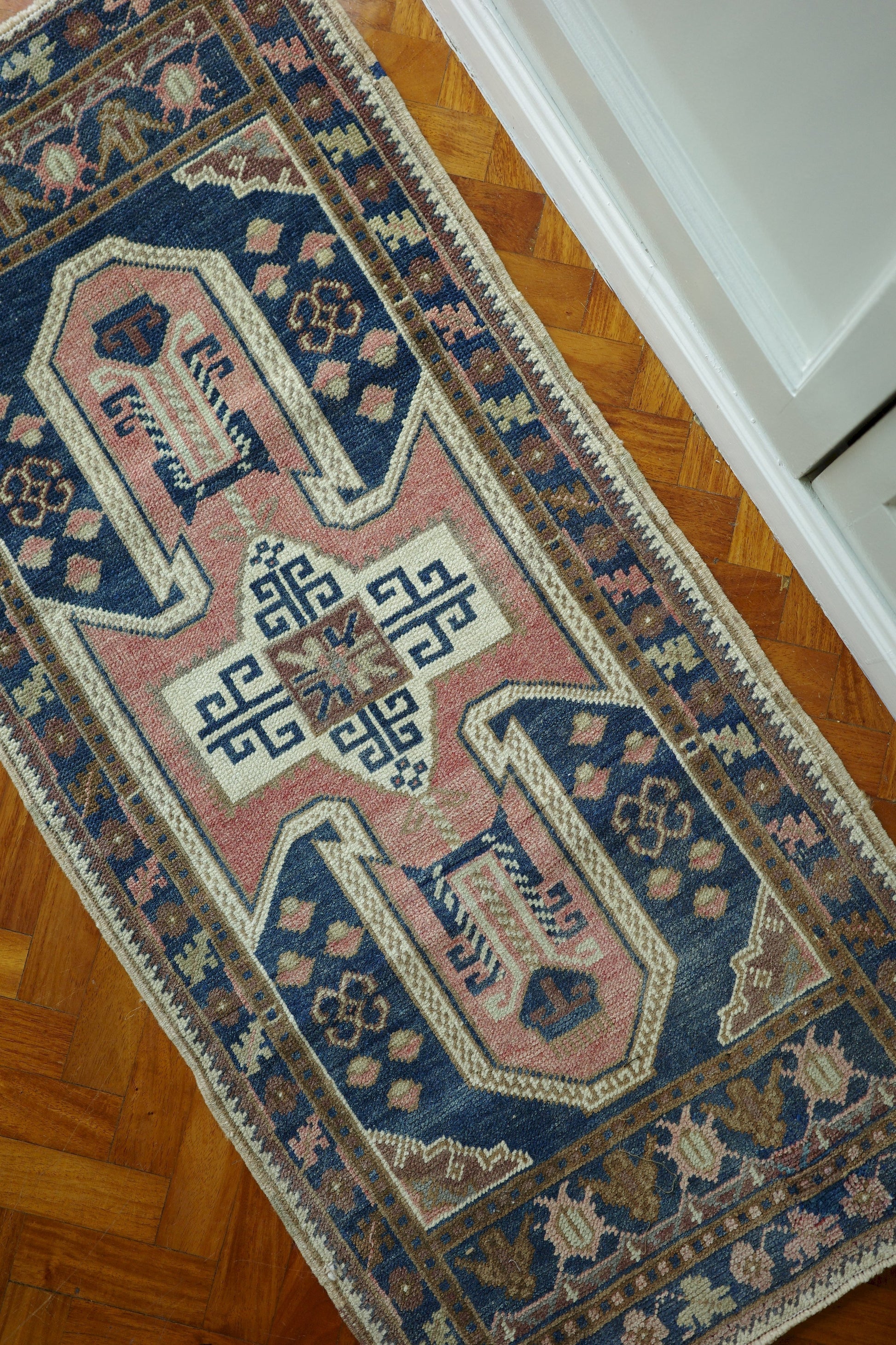 Handwoven Turkish Yastik rug with geometric patterns and rich colors