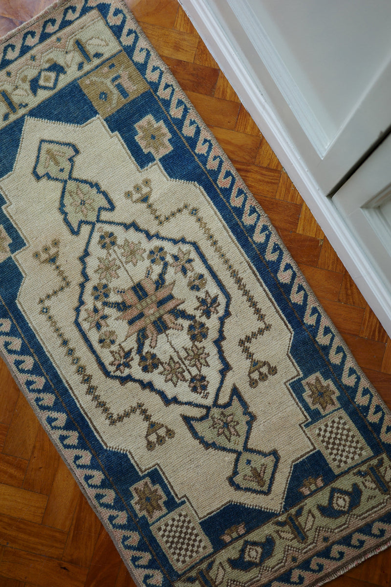 Handwoven Turkish Yastik rug with geometric patterns and rich colors