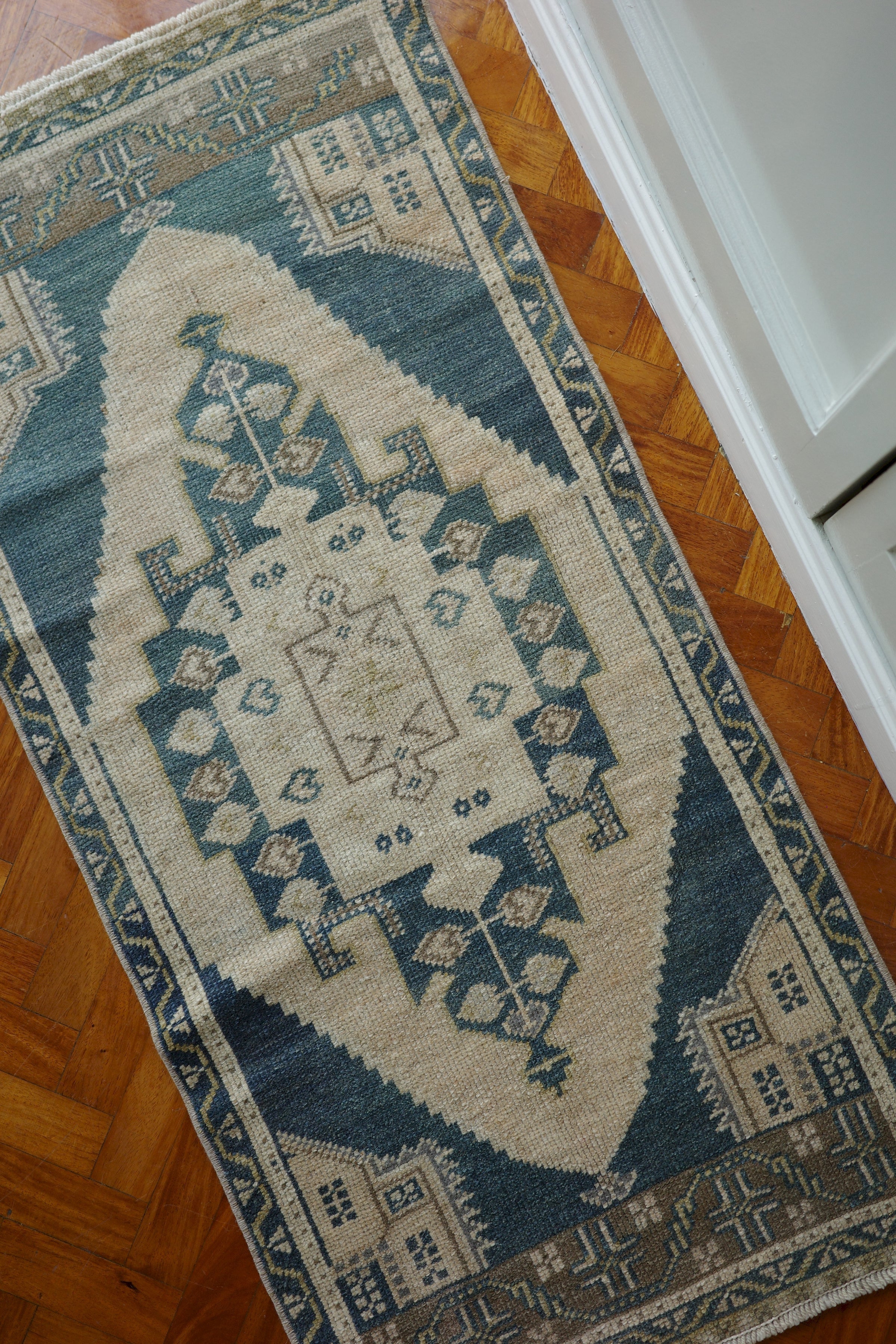 Handwoven Turkish Yastik rug with geometric patterns and rich colors