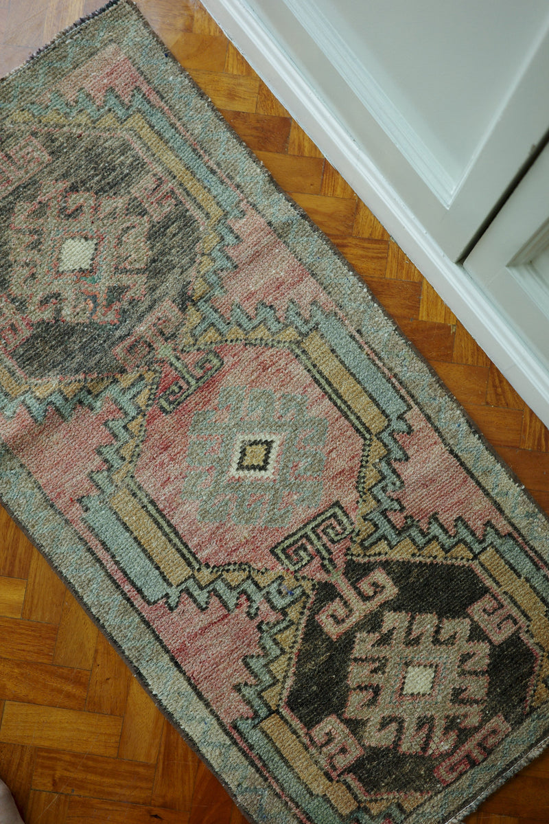 Handwoven Turkish Yastik rug with geometric patterns and rich colors