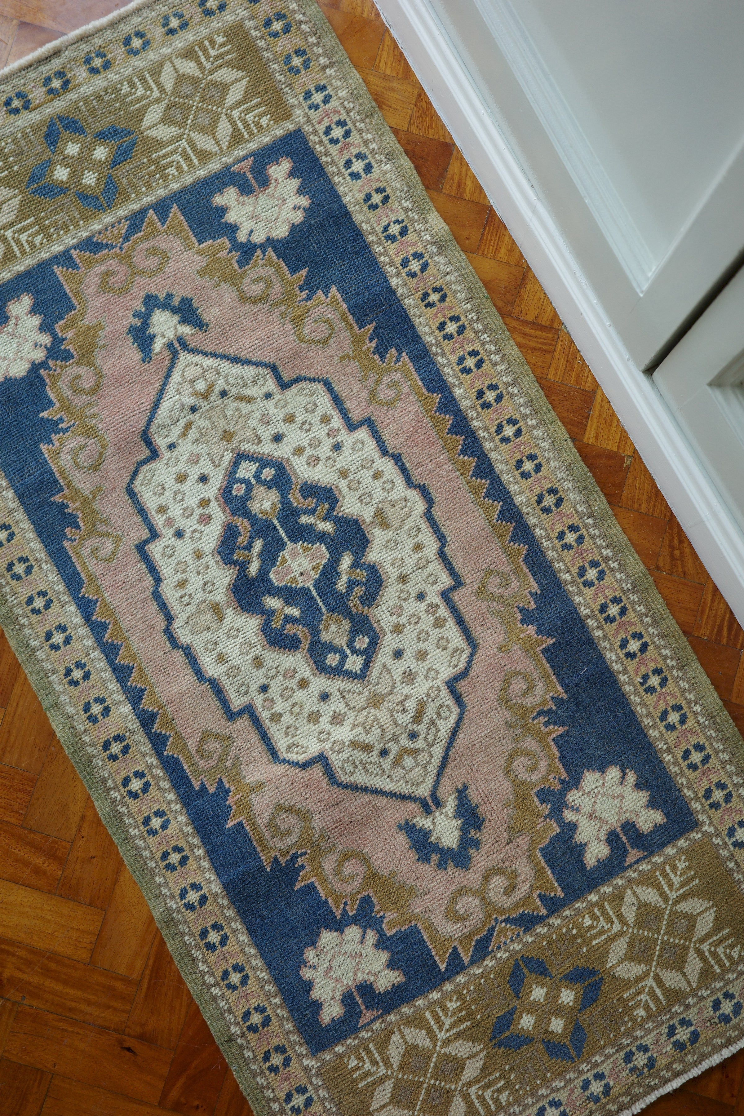 Handwoven Turkish Yastik rug with geometric patterns and rich colors