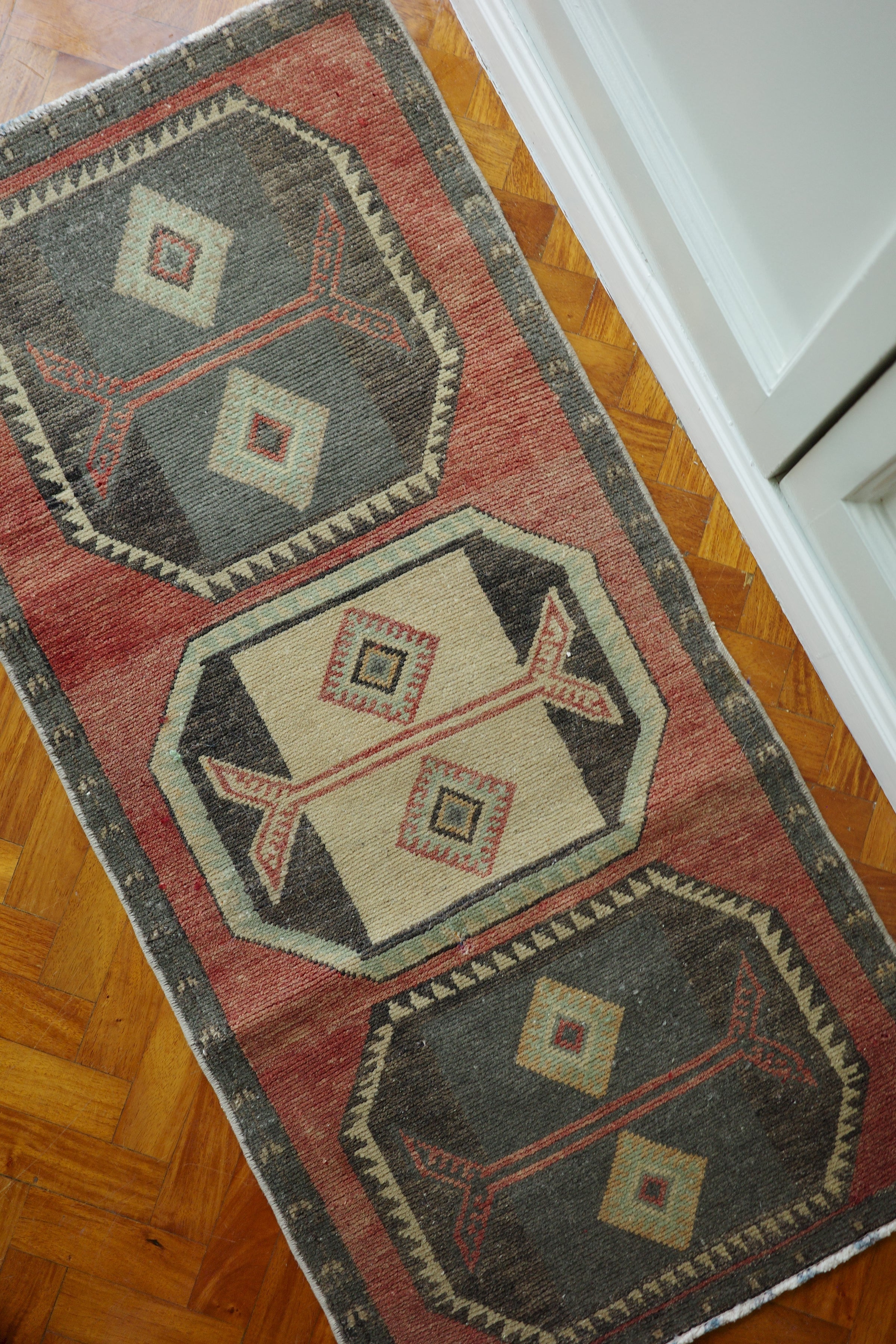 Handwoven Turkish Yastik rug with geometric patterns and rich colors