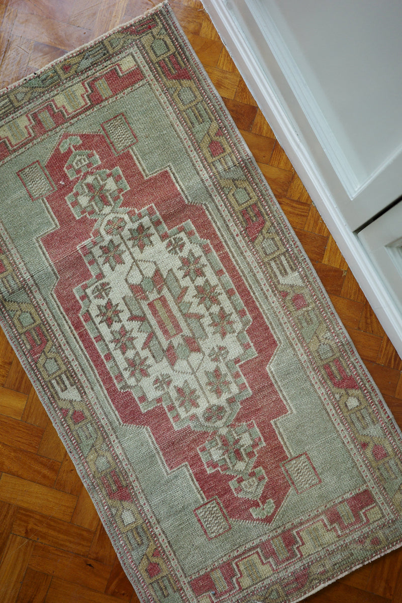 Handwoven Turkish Yastik rug with geometric patterns and rich colors