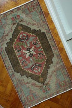 Handwoven Turkish Yastik rug with geometric patterns and rich colors