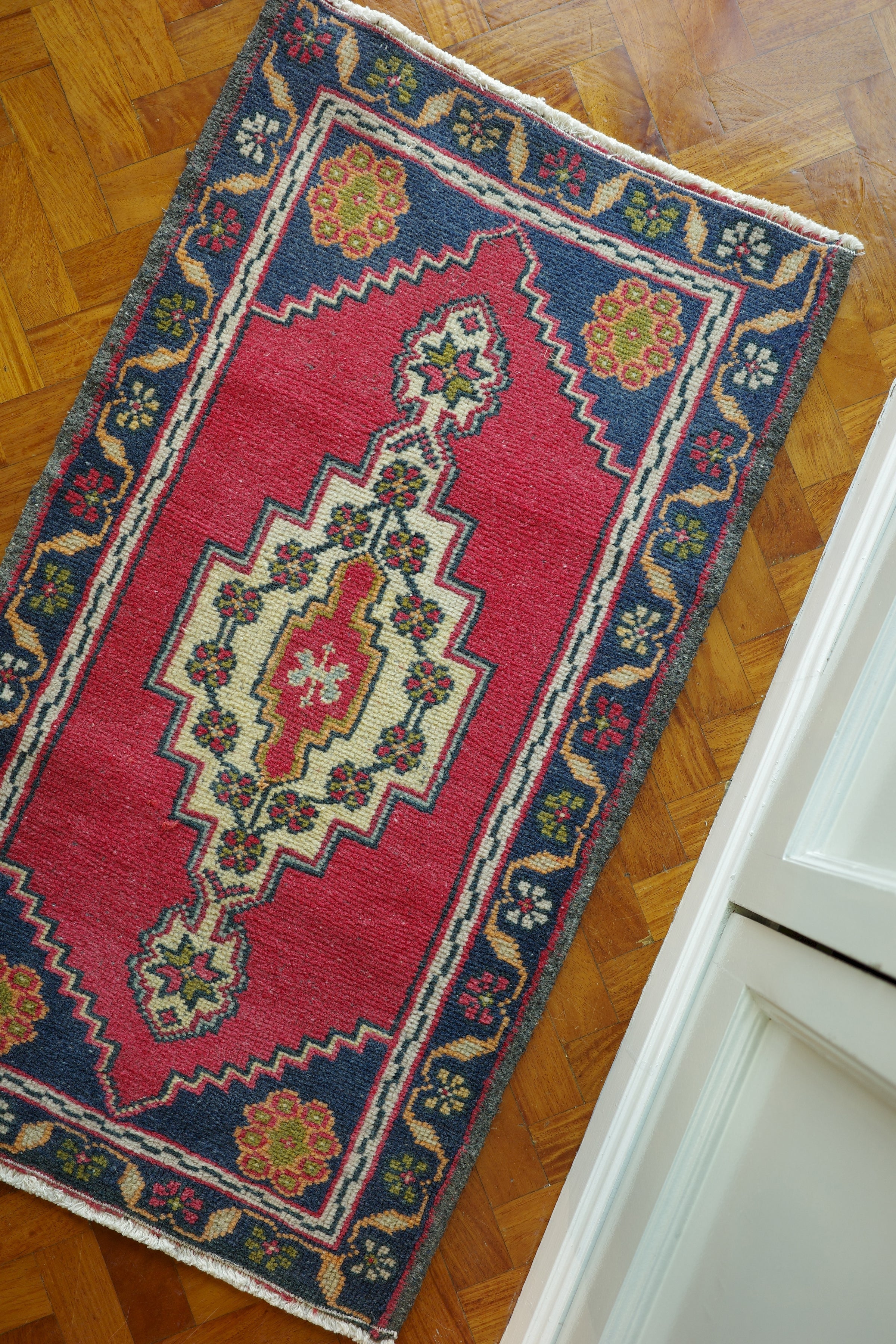 Handwoven Turkish Yastik rug with geometric patterns and rich colors