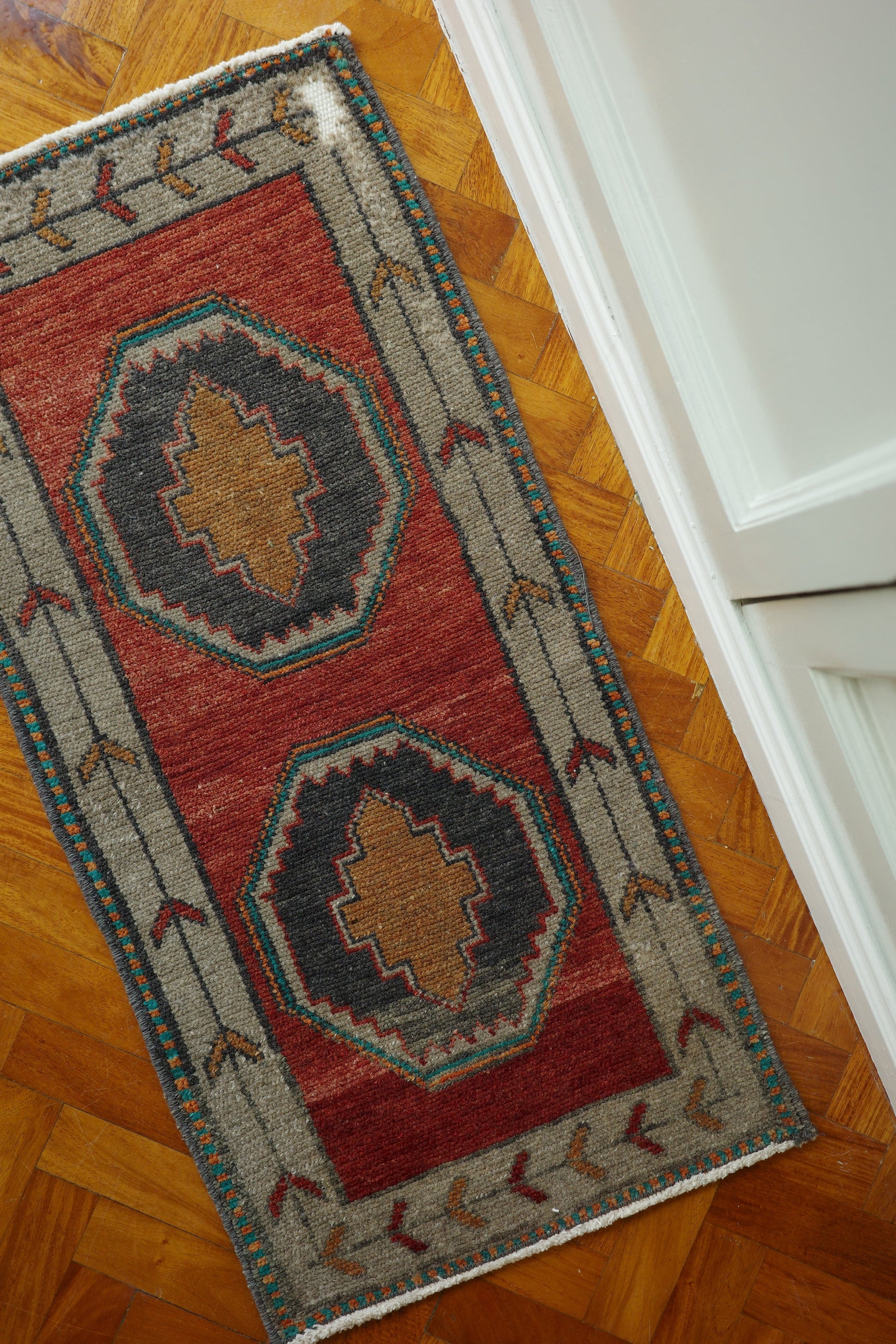 Handwoven Turkish Yastik rug with geometric patterns and rich colors