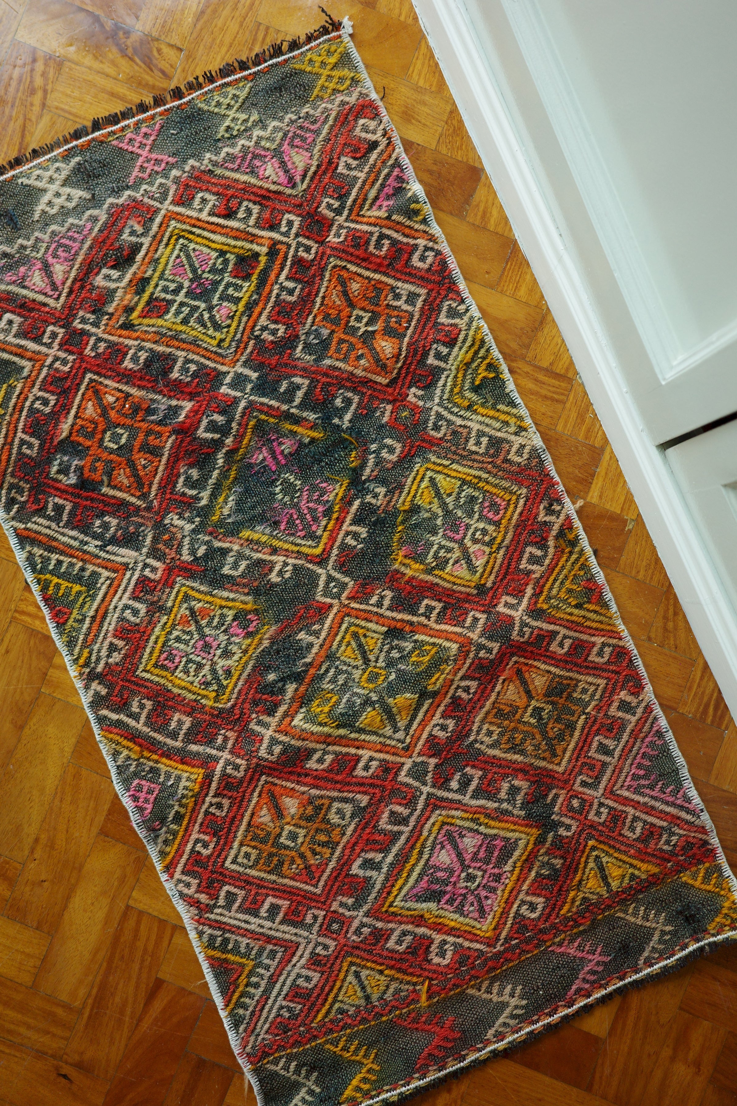 Handwoven Turkish Yastik rug with geometric patterns and rich colors