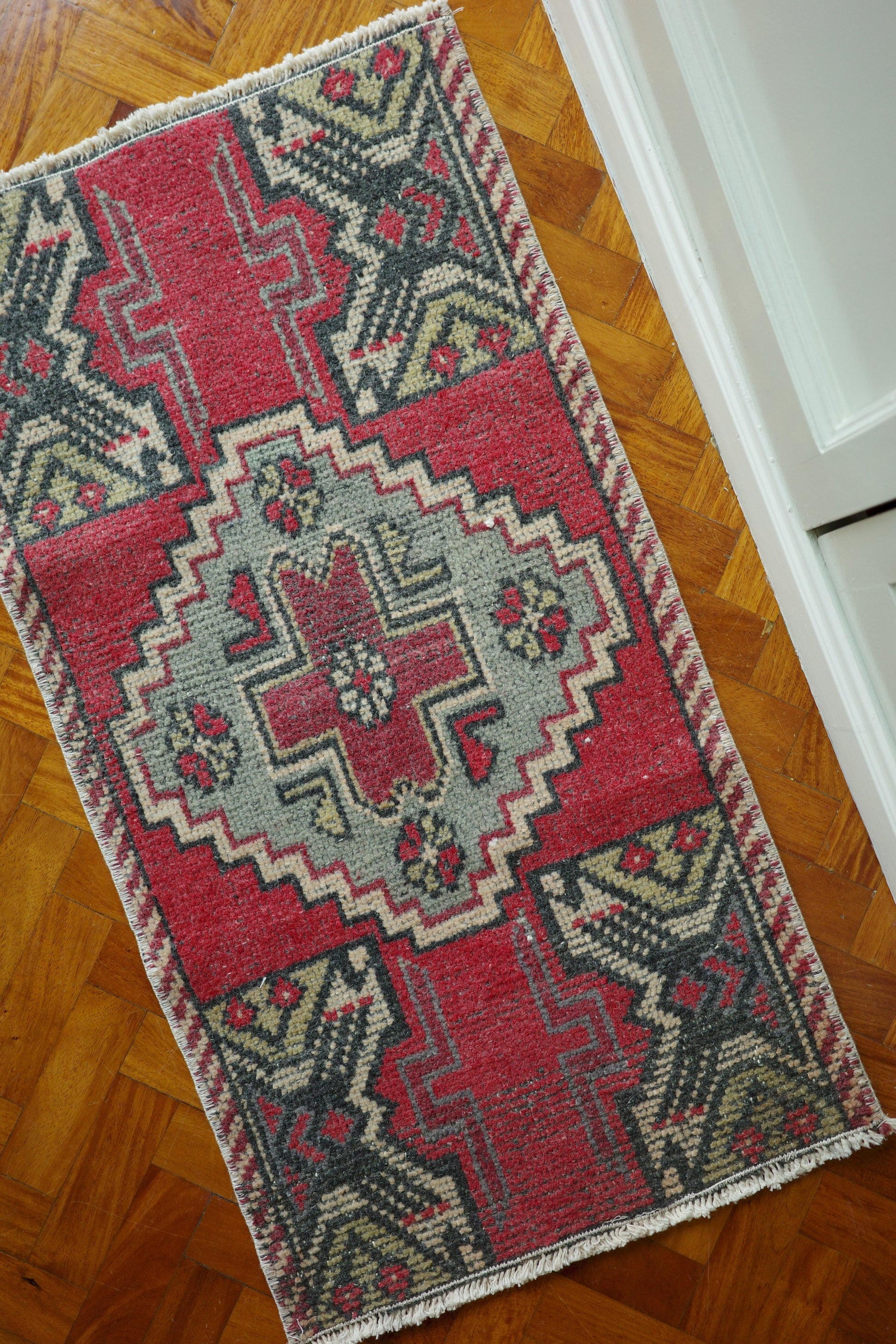 Handwoven Turkish Yastik rug with geometric patterns and rich colors