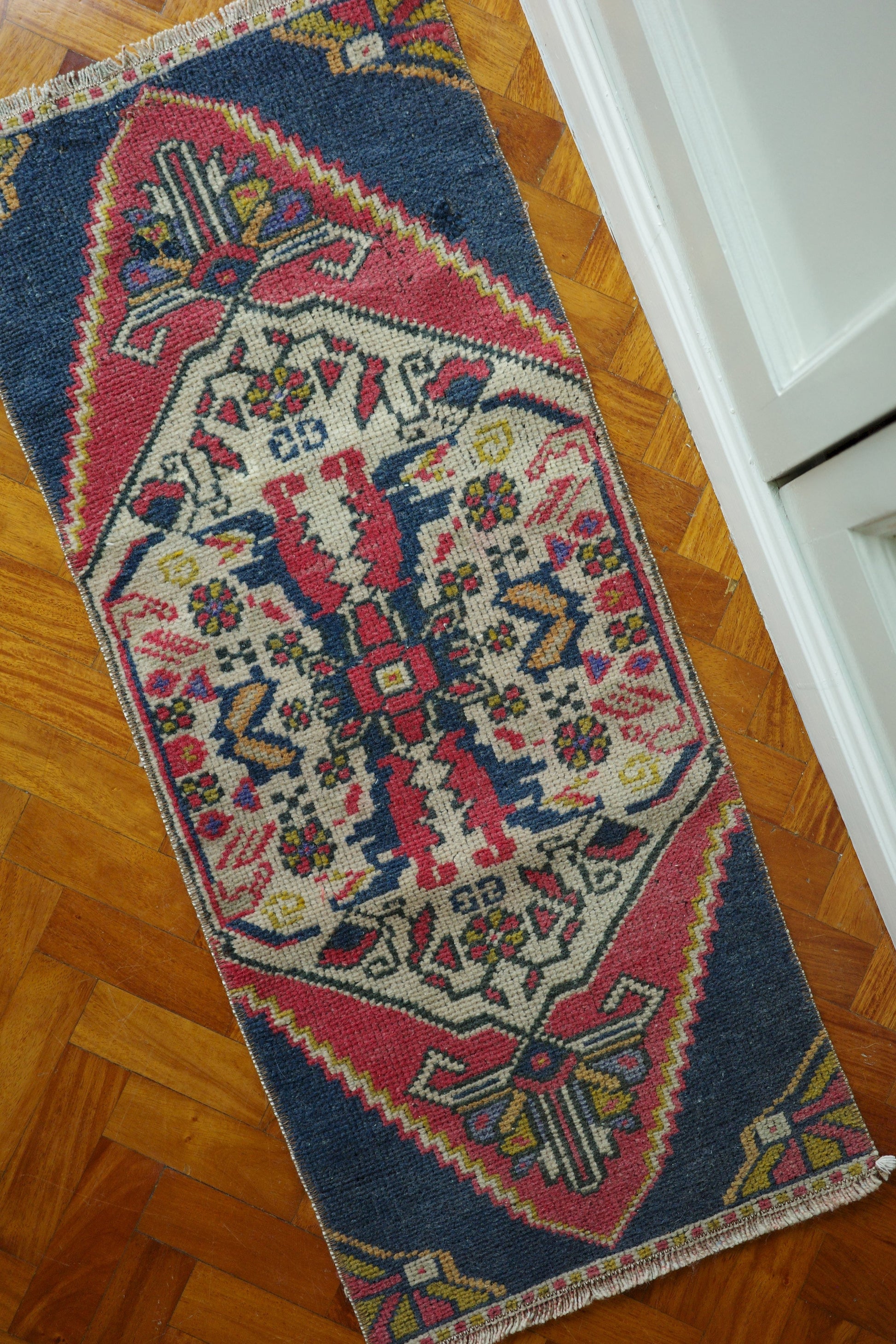 Handwoven Turkish Yastik rug with geometric patterns and rich colors