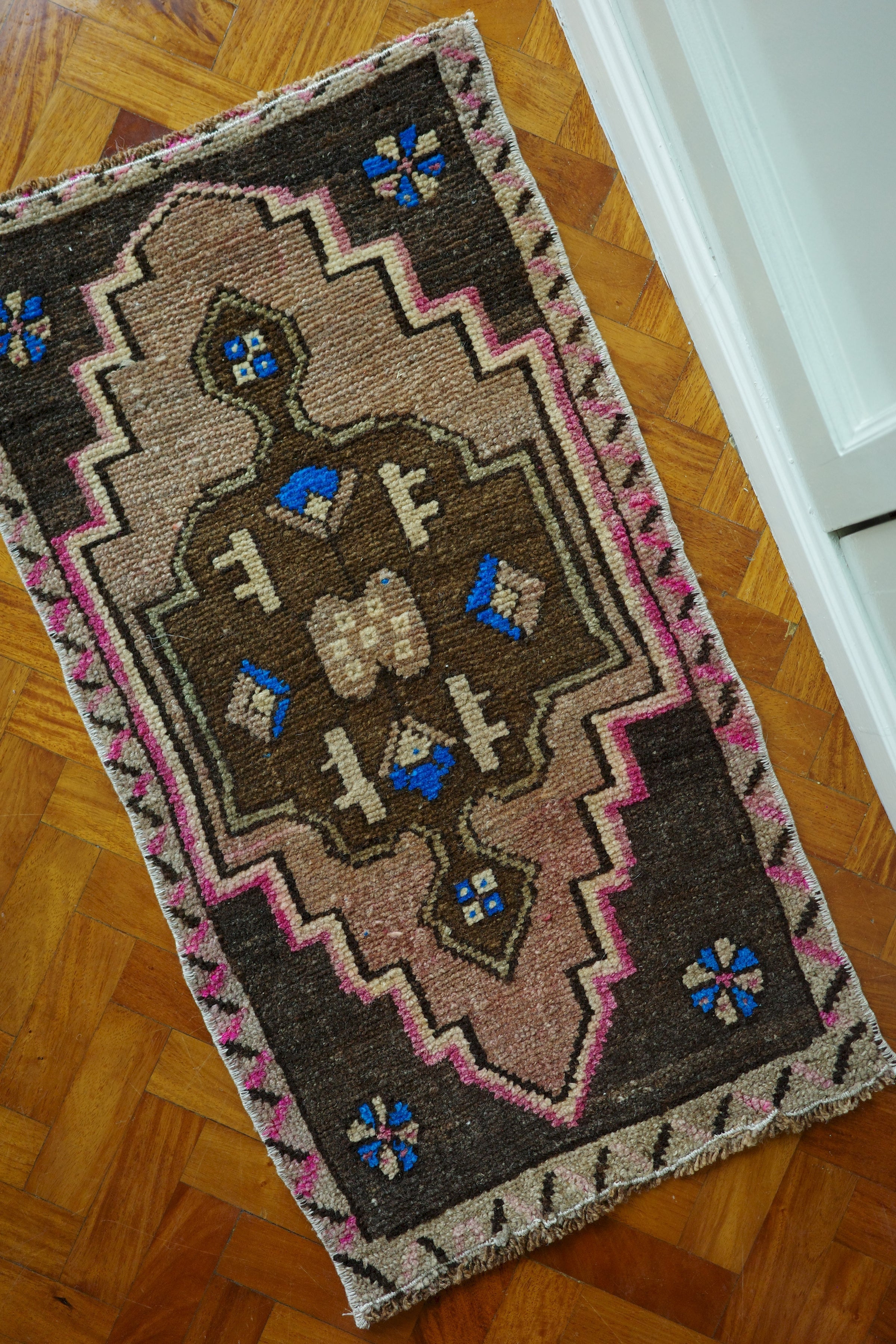 Handwoven Turkish Yastik rug with geometric patterns and rich colors