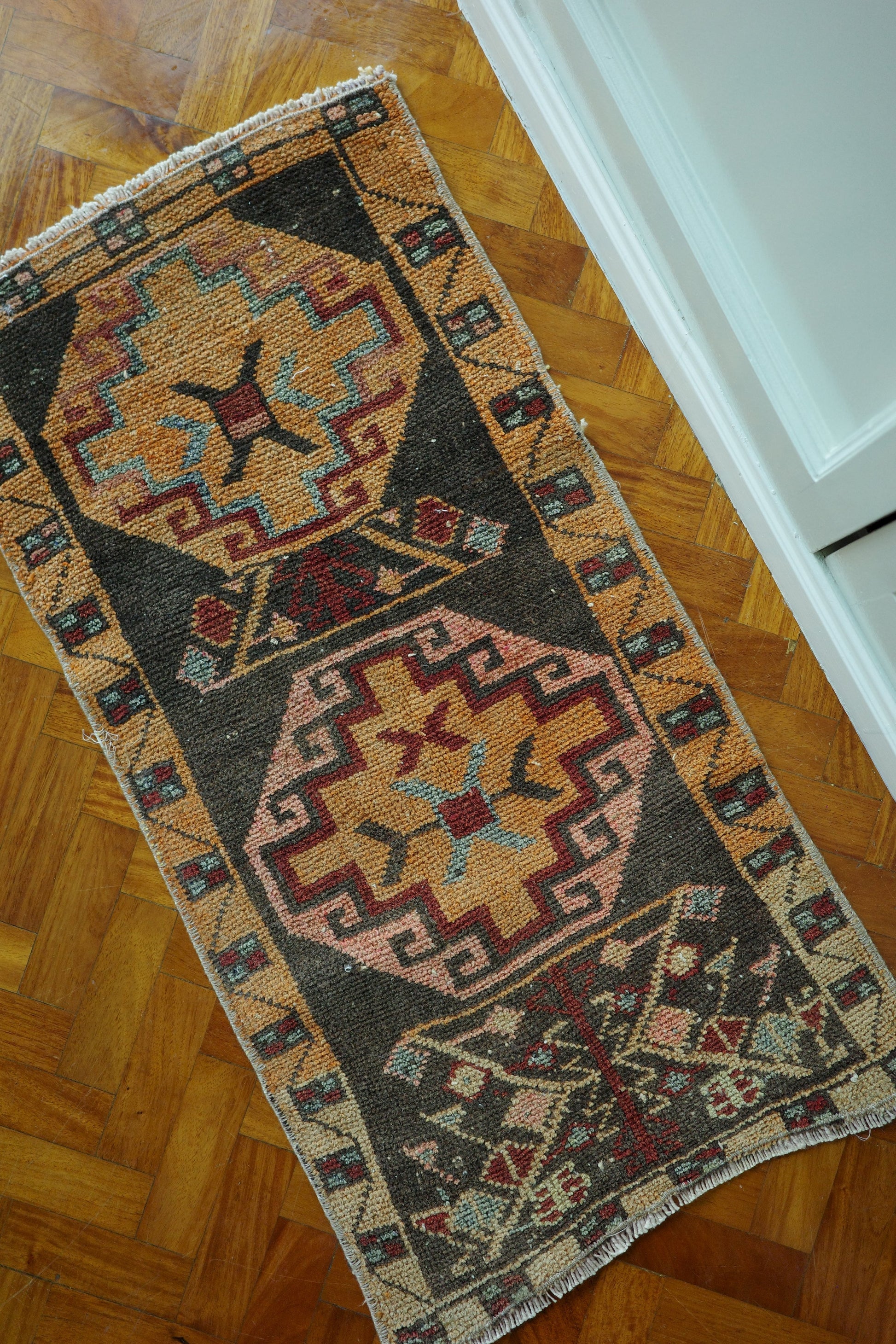 Handwoven Turkish Yastik rug with geometric patterns and rich colors